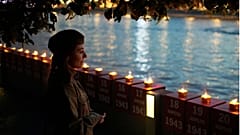 یک زن روس در برابر شمع‌های یادبود سربازان کشته‌شده کشورش