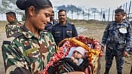 Ein nepalesischer Soldat blickt auf ein zwei Monate altes Baby, nachdem Retter sie und ihre Mutter in Dhunche im Distrikt Rasuwa aus Flutwasser befreiten.