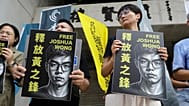 Hong Kong activist and supporters hold signs during a press event to support pro-democracy activist Joshua Wong in Taipei, Taiwan, Wednesday, 2 September, 2026