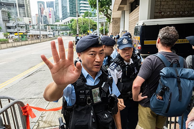 Police officers stand guard outside the High Court in Hong Kong, Wednesday, Sept. 2, 2026