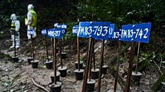 Identification number tags are seen on the bodies of flash flood victims as Nepalese police personnel carry out a mass burial in Kathmandu, 1 September, 2026