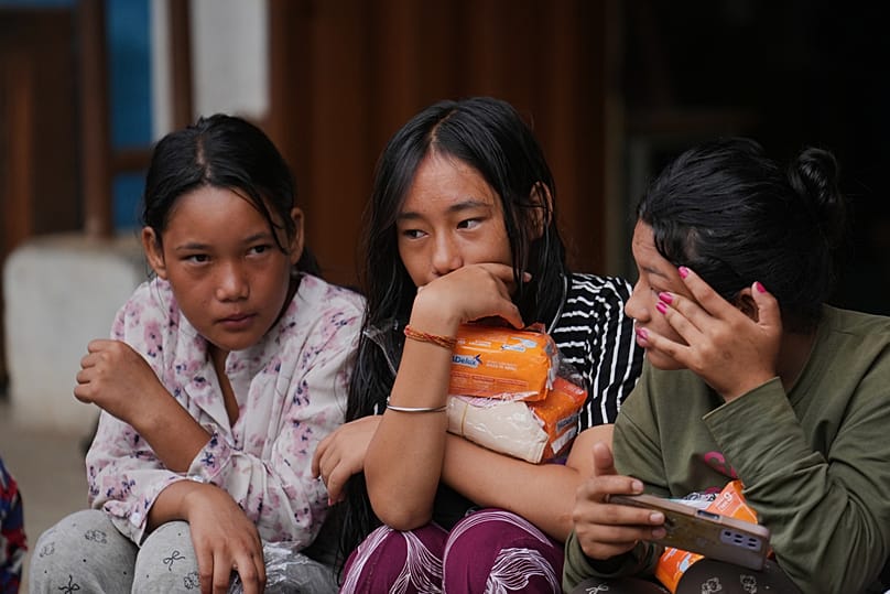 Displaced girls sit at a school converted into a temporary shelter for displaced residents in residents in Bidur, in Nepal's Nuwakot district, Tuesday, 1 September, 2026