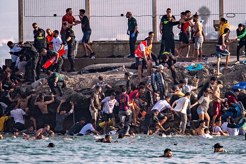 Migrants try to cross from Morocco into the Spanish enclave of Ceuta, 30 July, 2026