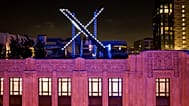 Workers install lighting on an "X" sign atop the company headquarters, formerly known as Twitter, in downtown San Francisco, on Friday, July 28, 2023. 