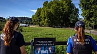 Police officers secure the area around the Schachen horse racing track following a shooting at a rave, in Aarau, Switzerland, Sunday Aug. 30, 2026.