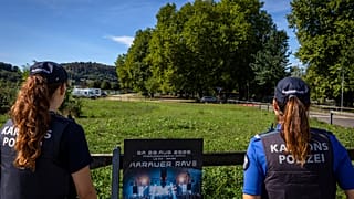Police officers secure the area around the Schachen horse racing track following a shooting at a rave, in Aarau, Switzerland, Sunday Aug. 30, 2026.