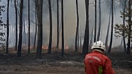 A firefighter works to extinguish a fire, near Blagon, southwestern France, 31 July 2026.