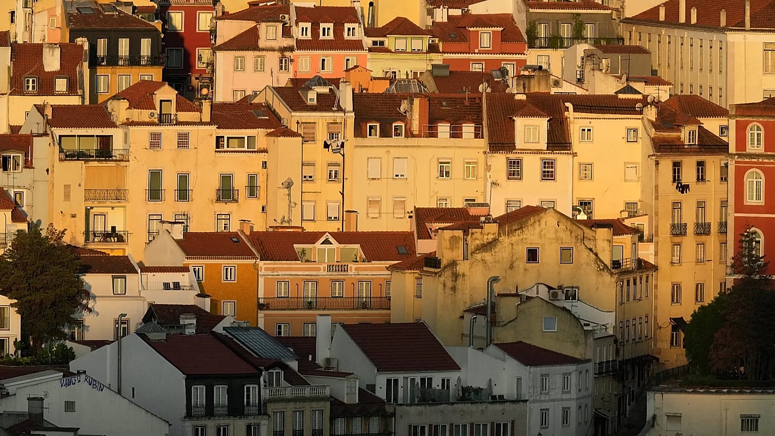 Buildings in downtown Lisbon are lit by the rising sun, Thursday, July 30, 2026.