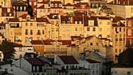 Buildings in downtown Lisbon are lit by the rising sun, Thursday, July 30, 2026.