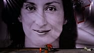 Flowers and a candle lie in front of a portrait of slain investigative journalist Daphne Caruana Galizia during a vigil in Valletta, 16 October, 2018