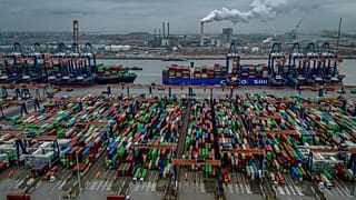 Trucks, containers and cargo ships are pictured at the new Maasvlakte terminal in the harbor of Rotterdam, Netherlands, Tuesday, Dec. 10, 2024.