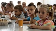 Children from an orphanage in Ukraine’s Donetsk region eat a meal at a camp in Zolotaya Kosa, Rostov region, southwestern Russia, July 8, 2022.