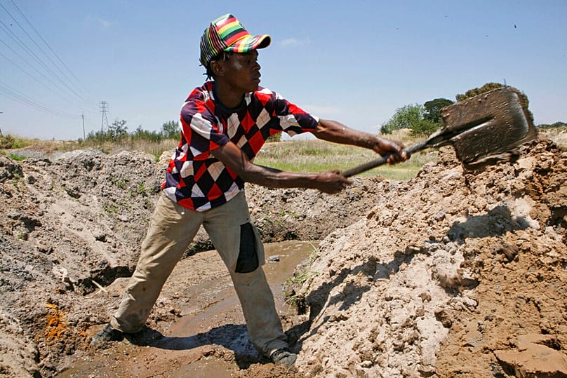 In this Friday Nov. 2, 2012 photo Siphelele Dyasi, digs soil during their illegal gold mining in Roodepoort, South Africa on Friday Nov. 2, 2012.