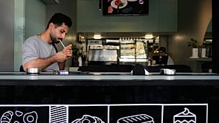 FILE: A man lights his cigarette at a cafe in Tehran, 10 August 2026