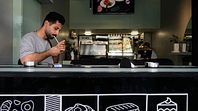 FILE: A man lights his cigarette at a cafe in Tehran, 10 August 2026