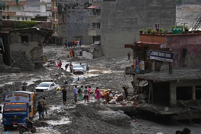 People salvage their belongings from a building damaged by flash flooding in Nuwakot district of Nepal, 1 September, 2026