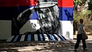 A woman walks by a mural that shows former Bosnian Serb wartime general Ratko Mladic in Belgrade, Serbia, Wednesday, Sept. 2, 2026. 