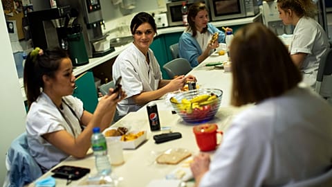 In this Wednesday, Dec. 16, 2020 file photo, Nurse Anne-Catherine Charlier, center, talks to colleagues during a dinner break in the intensive care ward for COVID-19 patients 