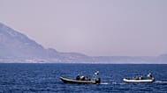 Motor boats take part in a search operation for people missing after a ferry disaster off the coast of Cyprus, near the port of Kyrenia.