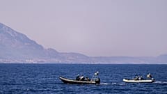 Motor boats take part in a search operation for people missing after a ferry disaster off the coast of Cyprus, near the port of Kyrenia.