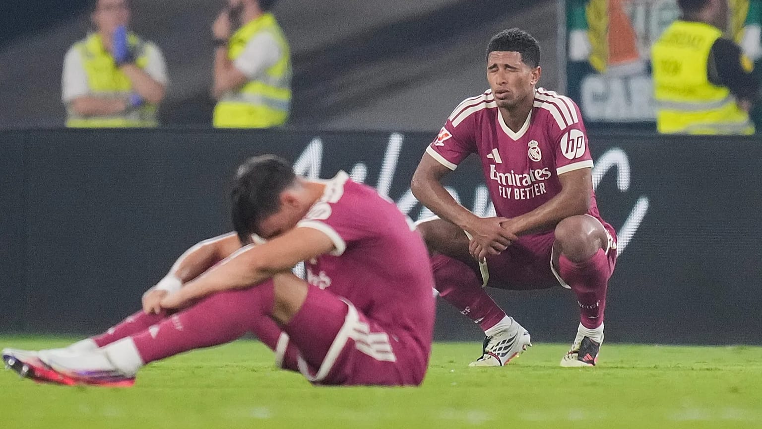 Real Madrid's Jude Bellingham, right, and Carlos Espi react after the Spanish La Liga soccer match between Real Betis and Real Madrid in Seville