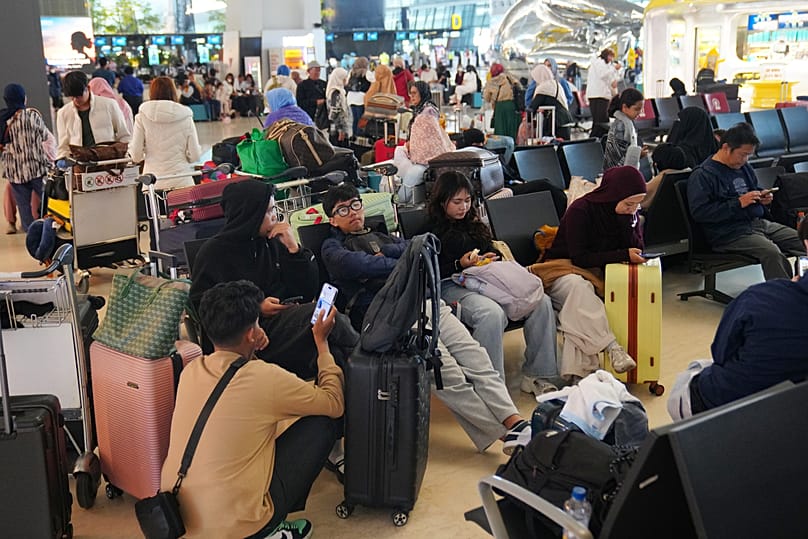 People wait as flights are disrupted due to the eruption of Mount Anak Krakatau at Soekarno-Hatta International Airport, 7 September, 2026