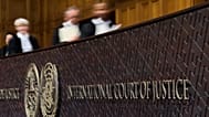 Judges walk to their seats in the International Court of Justice in The Hague, 22 October, 2025