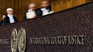 Judges walk to their seats in the International Court of Justice in The Hague, 22 October, 2025