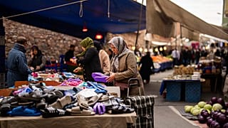 People buy goods and food at a street market in Istanbul, Turkey - FILE PHOTO
