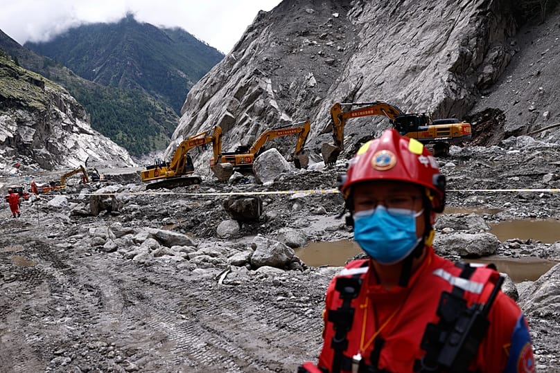A rescue worker stands near excavators at the core disaster-hit area at Gyirong Port in Tibet Autonomous Region, 6 September, 2026