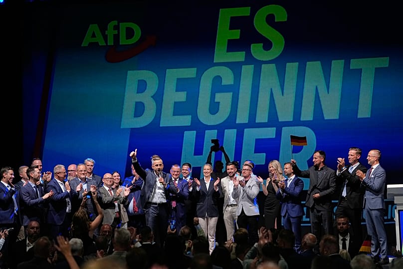 Top AfD candidate Ulrich Siegmund speaks in front of a reading "it starts here" at an AfD election party in Magdeburg, 6 September, 2026