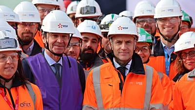 FILE. CEO of EDF Bernard Fontan and France's President Emmanuel Macron pose for a family picture during a visit of the Penly nuclear power plant in France, Mar. 2026