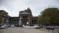Construction workers reinforce scaffolding on the Palace of Justice in Brussels. 