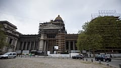 Construction workers reinforce scaffolding on the Palace of Justice in Brussels. 