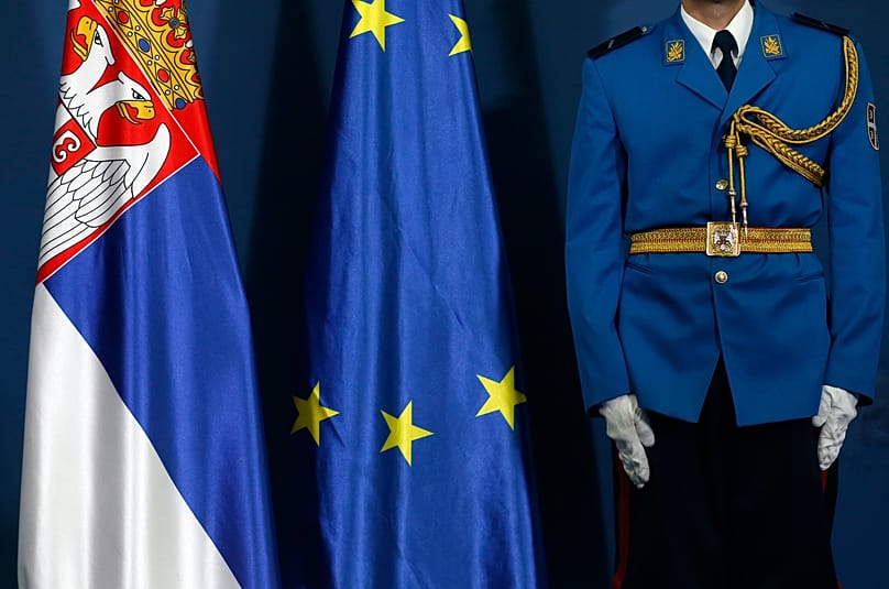 FILE: A member of the Serbian honour guard stands by Serbian and European flags in Belgrade, 2 October 2017