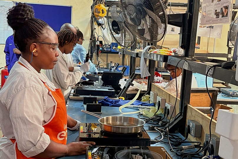 Workers assemble fuel-efficient cookstoves at BURN, a manufacturer of clean cooking appliances, in Kiambu, Kenya, on July 31, 2026. 