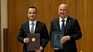Uzbek Minister Laziz Kudratov and Serbian Minister Nenad Popović present signed documents after the first Joint Economic Commission meeting in Belgrade.