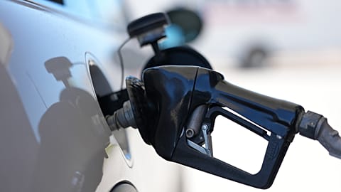 A driver fills a vehicle's tank at a petrol station