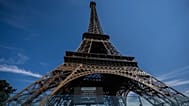 A sign is displayed announcing that the Eiffel Tower is closed at 4 p.m. due to a heat wave in Paris, Saturday, July 11, 2026. 