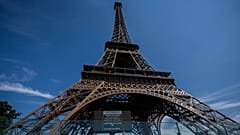 A sign is displayed announcing that the Eiffel Tower is closed at 4 p.m. due to a heat wave in Paris, Saturday, July 11, 2026. 