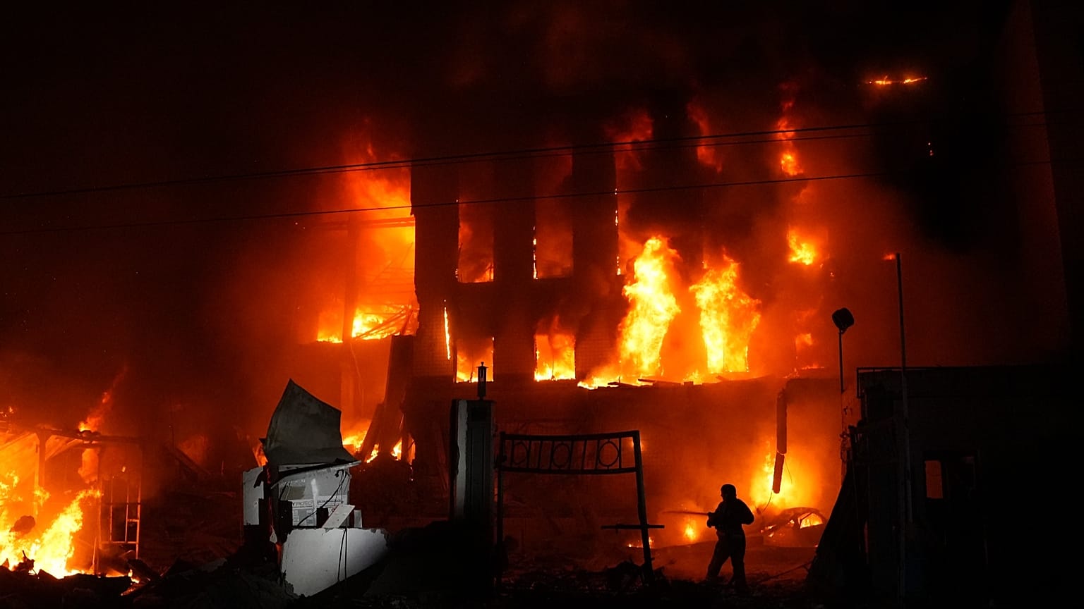 A rescue worker puts out a fire of a building destroyed after a Russian missile attack in Kyiv, 8 September, 2026
