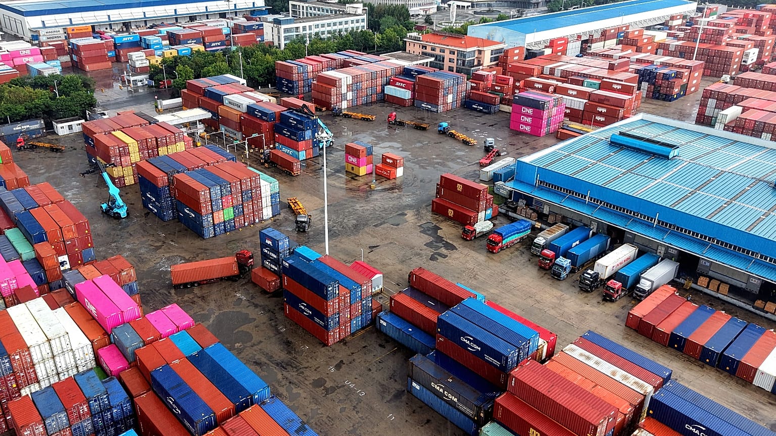 Containers are loaded and unloaded in trucks at terminal in Qingdao in eastern China's Shandong province on Aug. 28, 2026. (Chinatopix via AP)