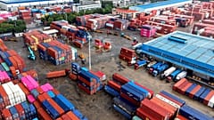 Des conteneurs sont chargés et déchargés dans des camions dans un terminal de Qingdao, dans le Shandong, dans l'est de la Chine, le 28 août 2026. (Chinatopix via AP)