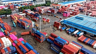 Containers are loaded and unloaded in trucks at terminal in Qingdao in eastern China's Shandong province on Aug. 28, 2026. (Chinatopix via AP)