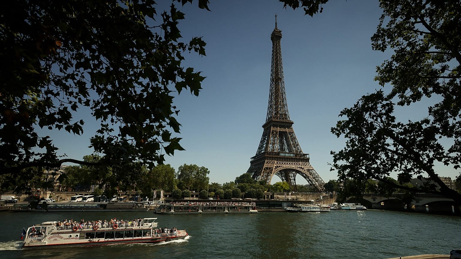 A tourist boat passes by the Eiffel Tower during a sunny day in Paris, 27 May, 2026