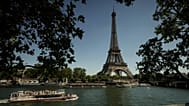 A tourist boat passes by the Eiffel Tower during a sunny day in Paris, 27 May, 2026