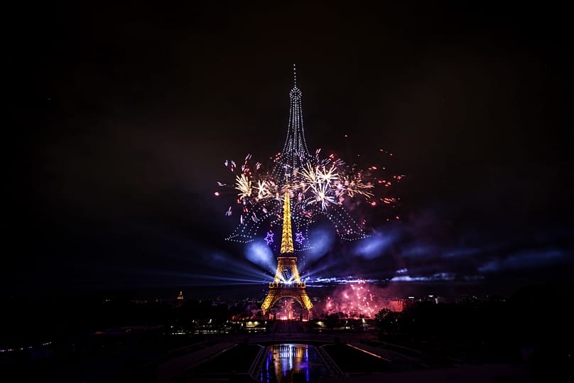 Fireworks and drones illuminate the Eiffel Tower in Paris on the eve of Bastille Day celebrations, 13 July, 2026 