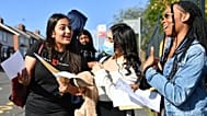 Students at Bristnall Hall Academy in Oldbury, England react as they receive their GCSE results Thursday August 20, 2020. 