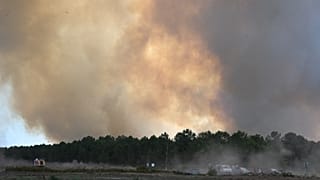 Smoke rises in the air during a fire in Martignas-sur-Jalles, during wildfires in the area of southwestern France, Tuesday, July 28, 2026. 