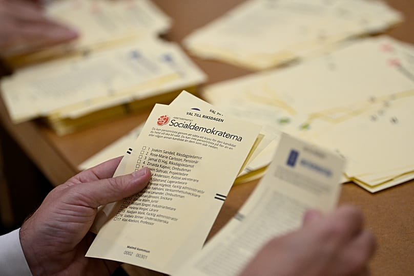 Poll workers count votes at a polling station at Hästhagens Sport Centre in Malmö, 11 September, 2022